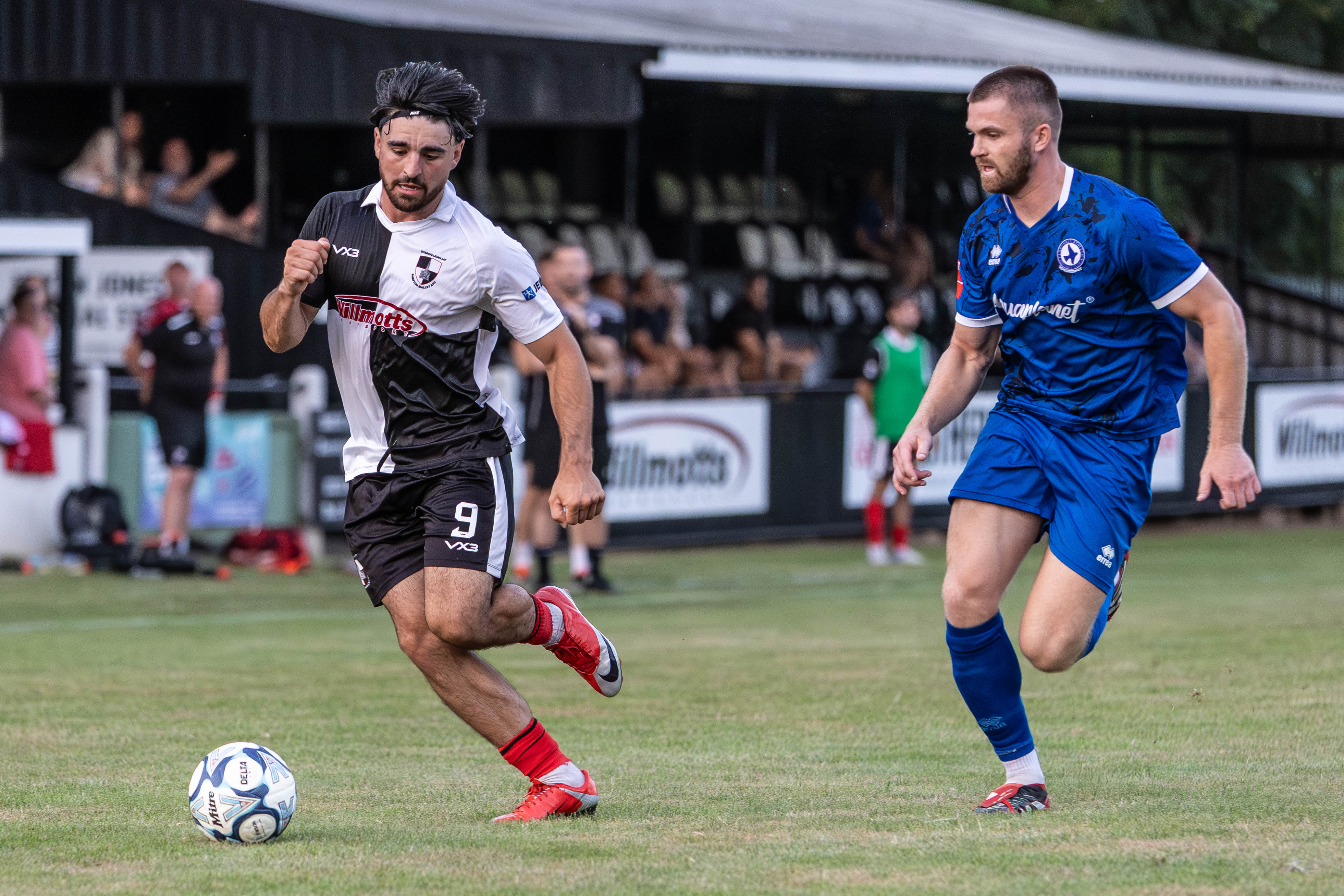 Footballer chasing down an opponent