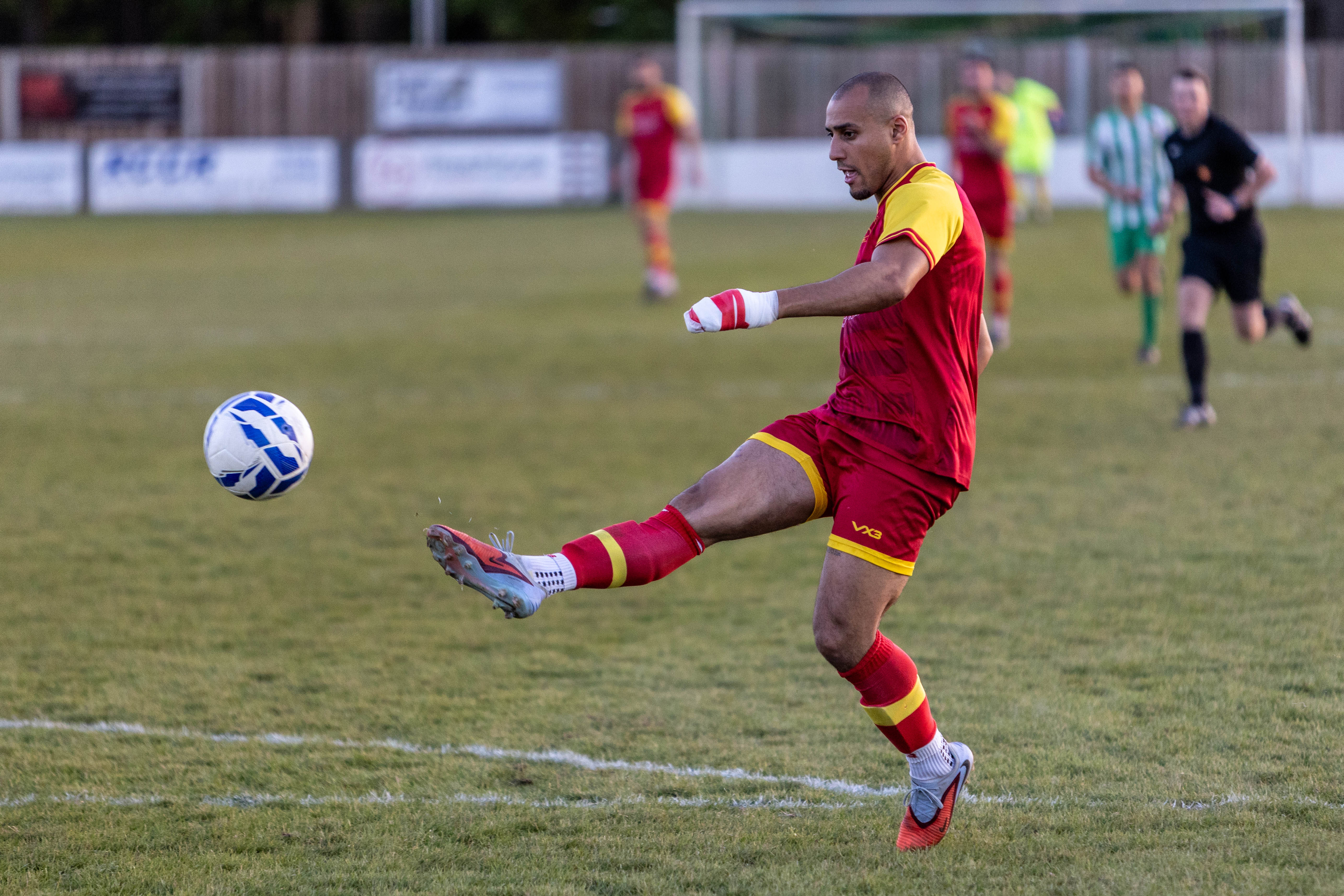 Footballer clearing the ball