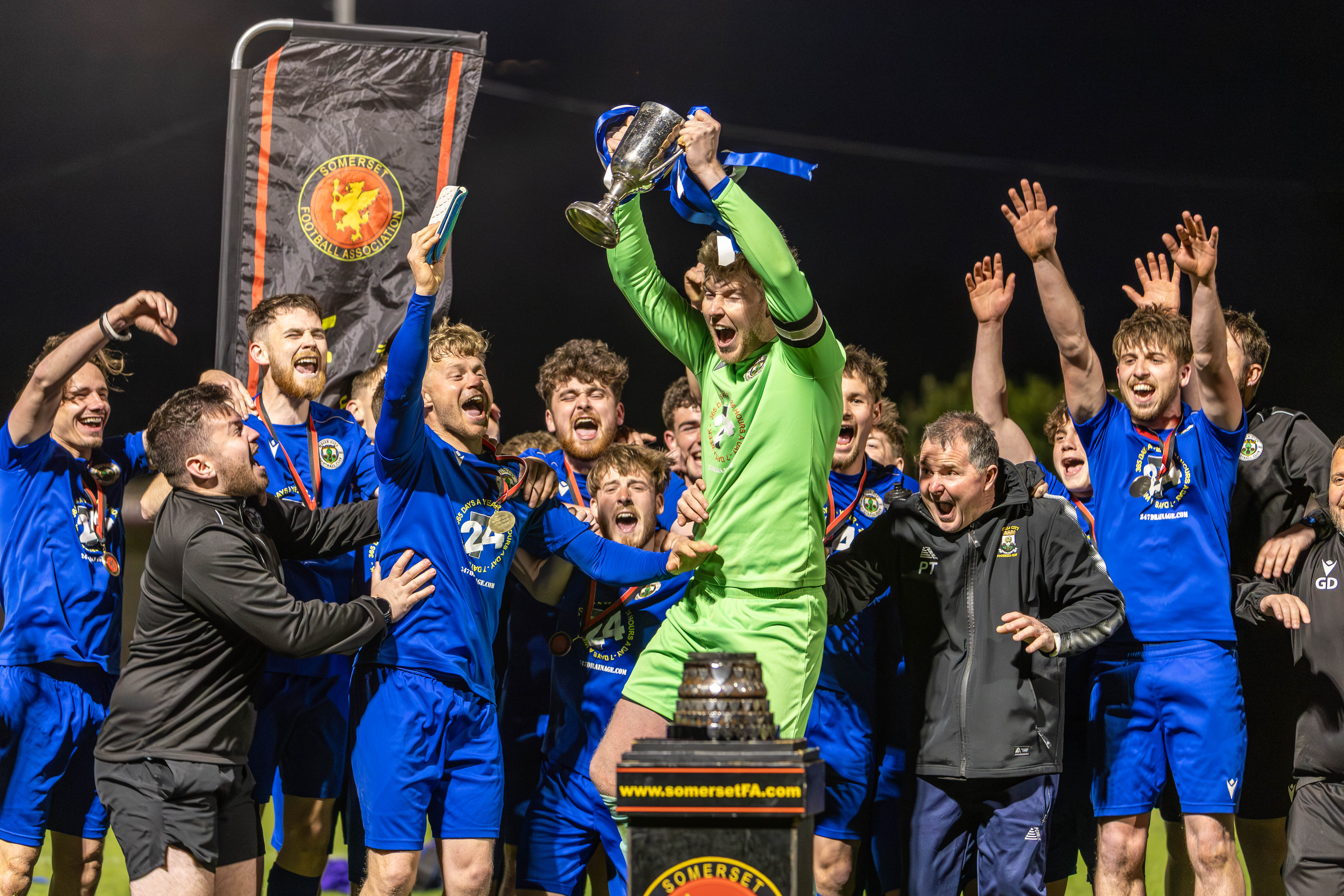 Football team celebrating with a trophy
